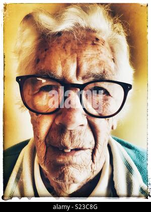 Elderly woman suffering from macular degeneration in her eyes Stock Photo