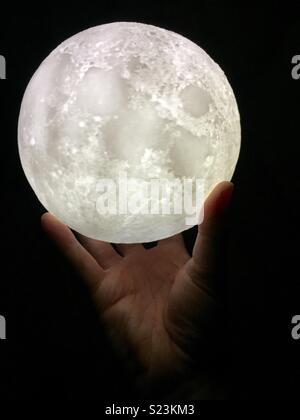 Hand holding moon globe. Stock Photo