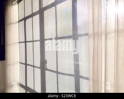 Sunlight streams through a casement window New York City apartment, NYC, USA Stock Photo