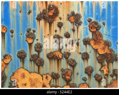 Orange & blue abstract rust patterns on metal. Stock Photo