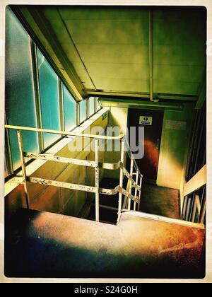Beautifully lit stairwell in abandoned building. Stock Photo