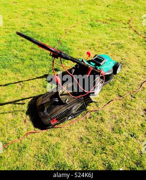 Lawnmower on freshly cut grass Stock Photo