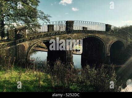 Picturesque stone bridge over river Stock Photo