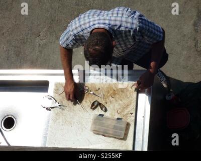 Fisherman preparing bait on Santa Monica Pier, Los Angeles, California, USA Stock Photo