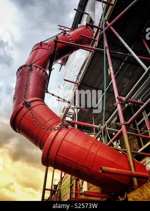 Builder’s buckets forming rubbish and waste chute Stock Photo