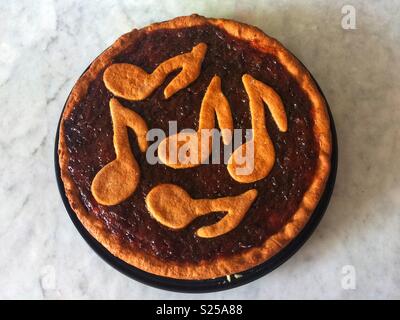 Whole spelt pie with plum marmelade and notes. Stock Photo