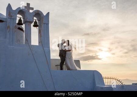 Wedding shot standing on the top of a chapel Stock Photo