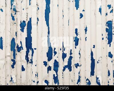 Flaking paint textures on the side of an old shipping container. Stock Photo