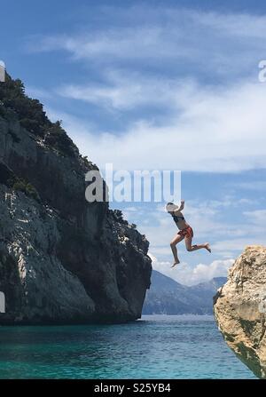 A girl jumping into the sea