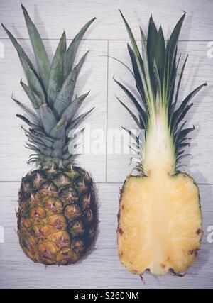 A fresh pineapple sliced in half on a white background Stock Photo