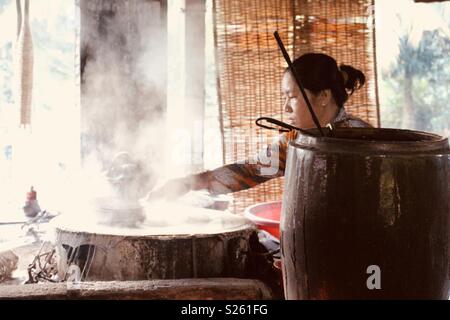 Vietnamese woman making rice paper in a rice paper factory Stock Photo