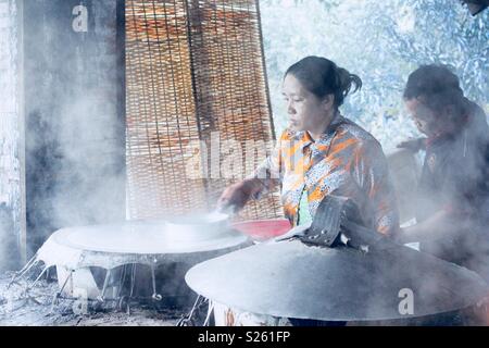 Vietnamese woman making rice paper in a rice paper factory Stock Photo