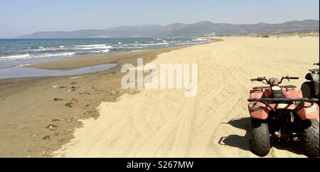 Quad biking on the beach in turkey Stock Photo