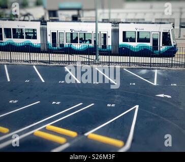 Sound transit link light rail train going through the city of Tacoma near empty parking lot Stock Photo