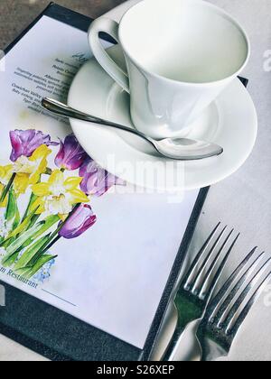 Menu and teacup on a table Stock Photo