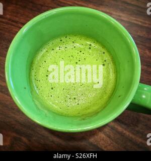 Matcha latte in green mug Stock Photo