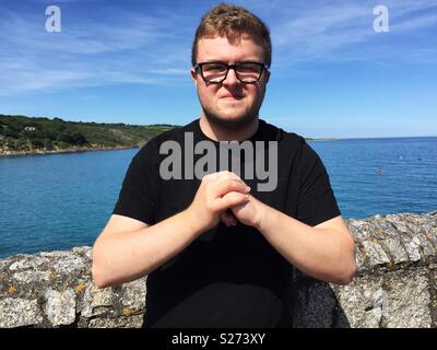 A man cracking his knuckles together Stock Photo