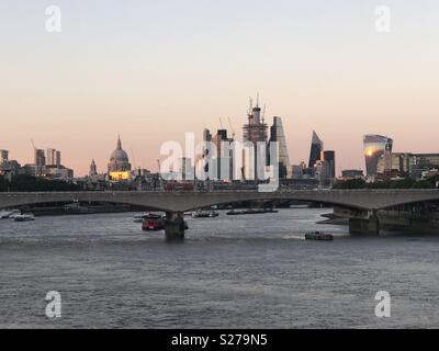 City of London and Waterloo Bridge at sunset from Hungerford Bridge Stock Photo