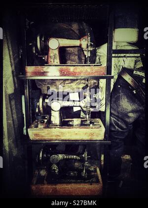 Stack of old sewing machines in shop window display. Stock Photo