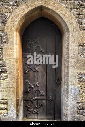 Ornate metal hinges on an old Church door Stock Photo