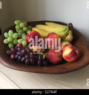 Fruit bowl with grapes bananas nectarines Stock Photo