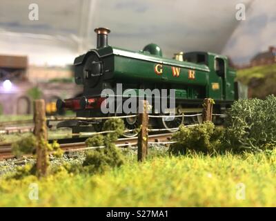 GWR tank engine passing fence. OO gauge model railway Stock Photo