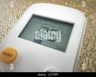Display of an air conditioner remote control with temperature set at 25 degrees Stock Photo