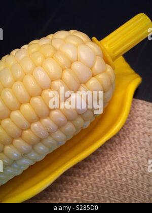 Fresh corn on the cob and cupholder on a special corn serving plate, USA Stock Photo