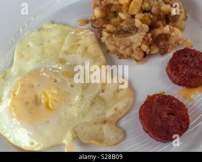 Traditional breakfast from Cape Verde; cachupa, fried egg and spicy sausage Stock Photo