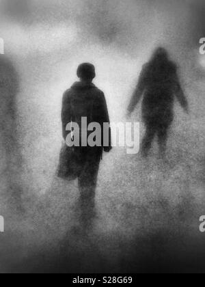 The rear view of figures in the fog Stock Photo