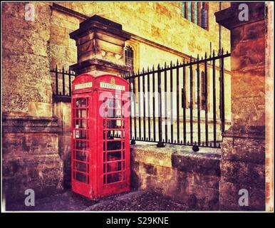 An iconic Red British public Telephone box or booth. The advent of cellphones has hastened their demise. A grunge picture with creative atmosphere. Photo Credit - © COLIN HOSKINS. Stock Photo