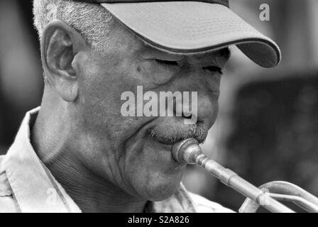 Old jazzy Cuban man playing the trumpet in Trinidad Cuba Stock Photo