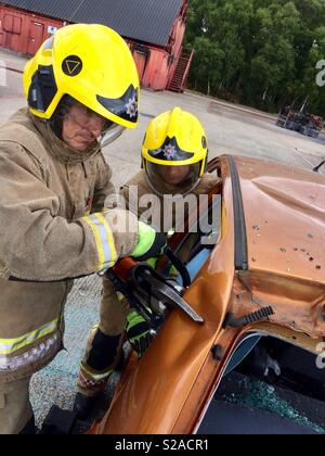 Firemen cutting car Stock Photo