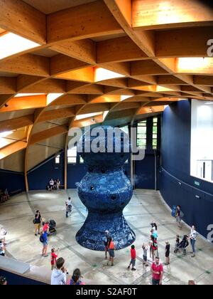 People looking at the Giant ‘breathing’ Infinity Blue sculpture in the invisible worlds section at the Eden Project in Cornwall, England Stock Photo