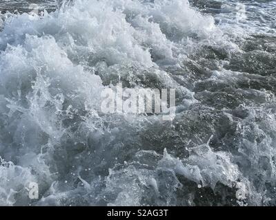 Turbulent water of a wake behind a boat on the River Welland Stock Photo