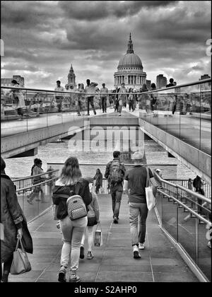 Looking north from the South Bank of The River Thames along The Millennium Bridge toward St. Paul’s Cathedral. Thousands of people walk over this iconic bridge every day. Photo Credit -© COLIN HOSKINS Stock Photo