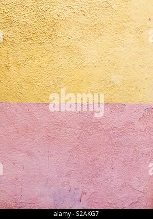 Two colours painted wall pink and yellow Stock Photo