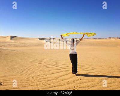 Young woman in desert, Sahara, Egypt Stock Photo