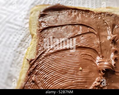 Chocolate cream spread on a slice of bread Stock Photo