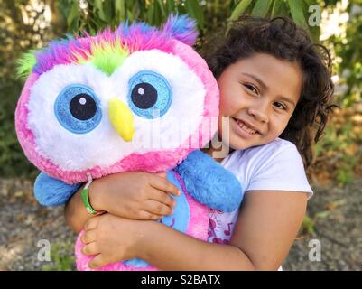 Little girl with owl plush. Stock Photo