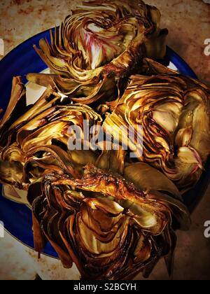 Roasted artichokes on a plate Stock Photo