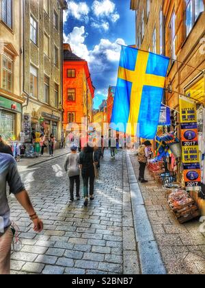 Swedish flag flying on Vasterlanggatan, Gamla stan, Stockholm, Sweden Stock Photo