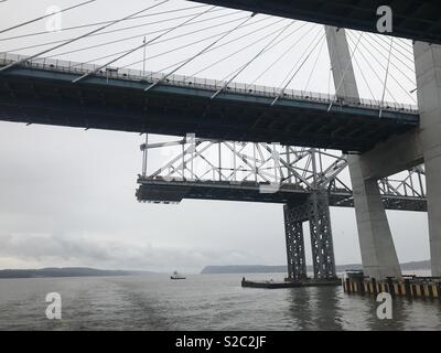 New Tappan Zee suspension Bridge in front of old bridge remains, over the Hudson River. Official name is the Governor Mario M. Cuomo bridge Stock Photo