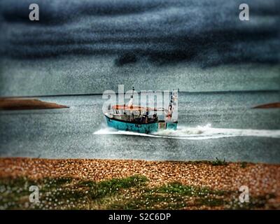 Fishing boat entering the river Ore from the North Sea at Shingle Street, Suffolk, UK. Stock Photo