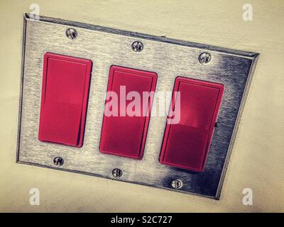 Commercial light switch with three rockers on /off switches, USA. Stock Photo