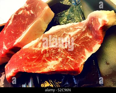 Raw New York strip steaks, close up, detail, USA Stock Photo