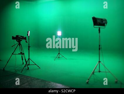 Videocamera and led lights in a greenkey studio ready for a television shoot Stock Photo