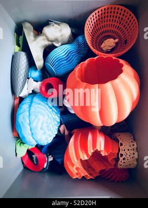 3D printed objects in a box, top view. 3D prints Stock Photo