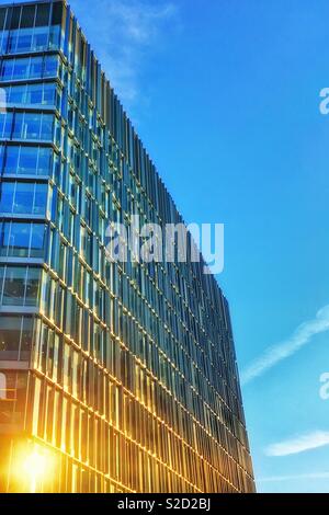 Sun reflecting in widows of office block Stock Photo
