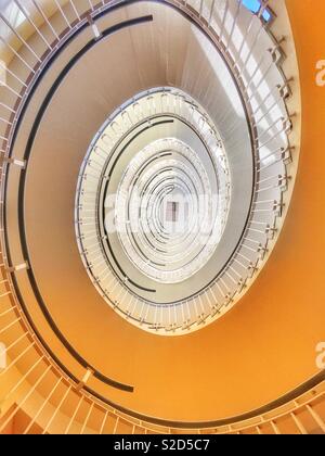 Looking up at a spiral staircase Stock Photo